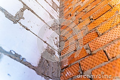 Comparison of brickwork and aerated concrete masonry. The junction of walls from different building materials Stock Photo