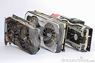 A comparison photo of a used ICHILL GEFORCE GTX 1080 X4, PALIT GTX1070, and GIGABYTE GT Editorial Stock Photo