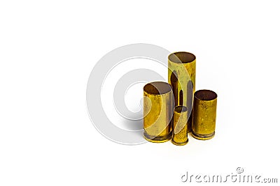 Comparison of sizes of different used bullet shells on a white isolated background with reflection from a tin table top. View of Stock Photo