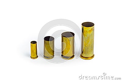 Comparison of sizes of different used bullet shells on a white isolated background with reflection from a tin table top. View of Stock Photo