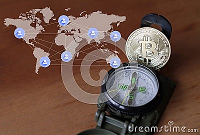 Compass and Bitcoin next to world map Stock Photo