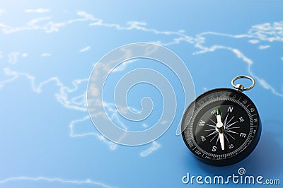 Compass on blue world map. Stock Photo