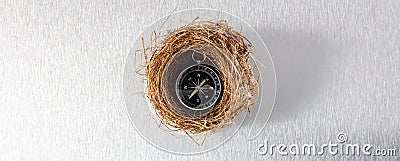 Compass in comfortable nest for safe travel or insured adventure Stock Photo