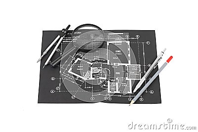 A compass, magnifier and a pencils over a construction drawing o Stock Photo