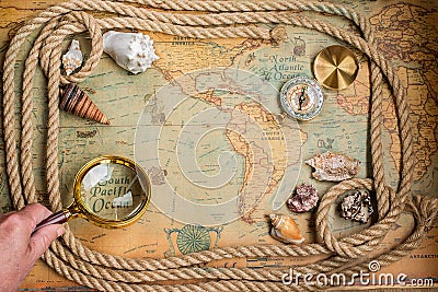 Compass, magnifier and rope on vintage map Stock Photo