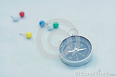 Compass and marking pins on canvas background Stock Photo