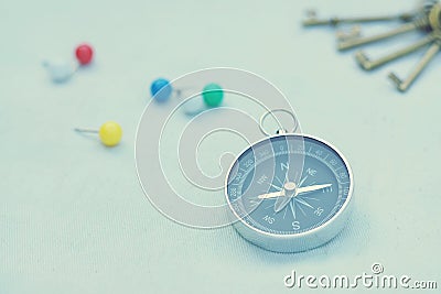 Compass and marking pins on white canvas background Stock Photo