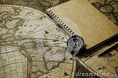 Compass and notebook on blur vintage world map, journey concept, copy Stock Photo