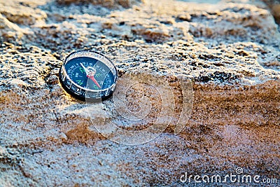 Compass on rock, copy space. Vacation travel or Travelling around world. Summer time. Backpacking. Travel destinations. Stock Photo