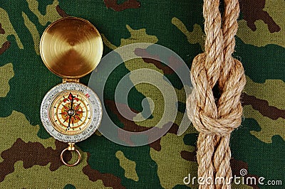 Compass and rope on a camouflage Stock Photo