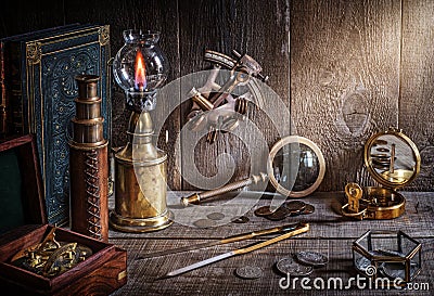 Compass, telescope, sextant, coin, divider and old book on wood desk Stock Photo