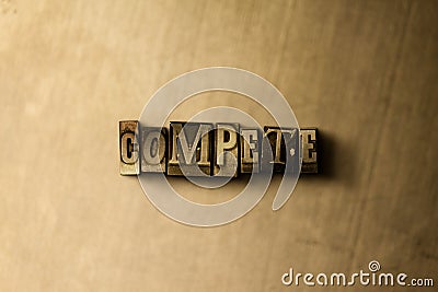 COMPETE - close-up of grungy vintage typeset word on metal backdrop Stock Photo