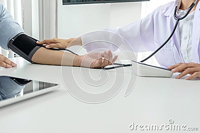 Competent attentive doctor being measuring blood pressure to pat Stock Photo