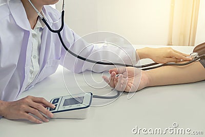 Competent attentive doctor being measuring blood pressure to pat Stock Photo