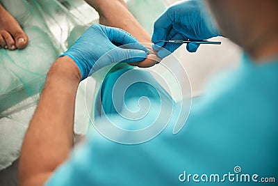 Close up of professional podologist doing medical pedicure Stock Photo