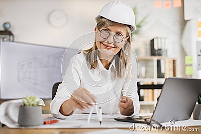 Competent mature female engineer, designer or architect leading working conference at office center. Stock Photo