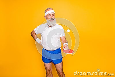 Competetive emotional cool active comic grandpa with beaming grin, with table tennis equipment. Healthcare, weight Stock Photo