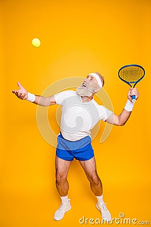 Competetive emotional cool grandpa with humor grimace exercising Stock Photo