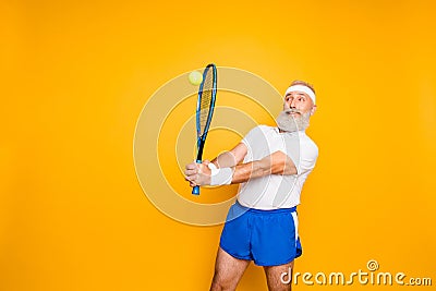 Competetive emotional cool grandpa with humor grimace exercising Stock Photo