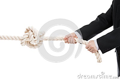 Business man hand holding or pulling rope with tied knot Stock Photo