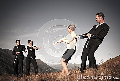 Competitive Business People Struggling To Win Tug-Of-Wars Stock Photo