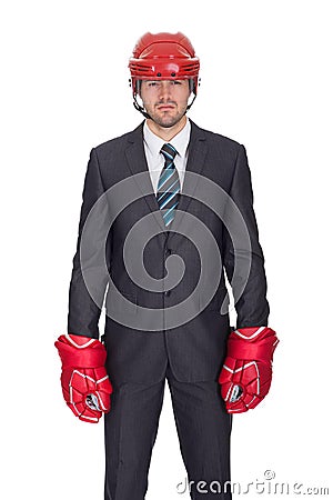 Competitive businessman wearing hockey equipment Stock Photo