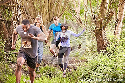 Competitors running in a forest at an endurance event Stock Photo