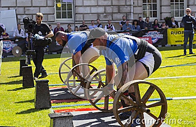 Competitors strain in the power lifting heat of the Ultimate Strongest Man competition. Editorial Stock Photo