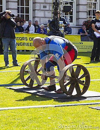 Competitors strain in the power lifting heat of the Ultimate Strongest Man competition. Editorial Stock Photo