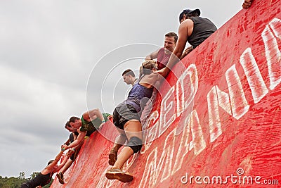 Competitors Struggle To Climb Wall In Extreme Obstacle Course Race Editorial Stock Photo