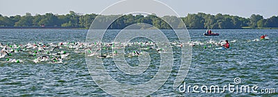 Competitors swimming at the beginning of the swimming stage of Triathlon. Editorial Stock Photo