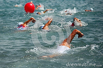 Competitors swimming out into open water Stock Photo