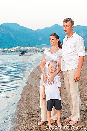 Complete family with son on the sea Stock Photo