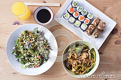Complete healthy meal of sushi and salad on a wooden table Stock Photo