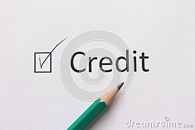 Complete loan payments. Pay loan. word CREDIT is written on white paper in pencil. Stock Photo