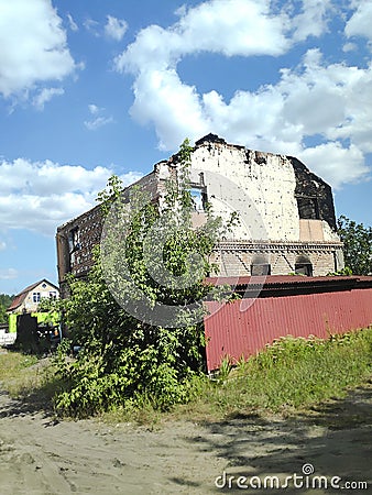 Completely destroyed brick residential building.House ruins damaged by enemy aircraft, missile strike,rocket attack by Russian Editorial Stock Photo
