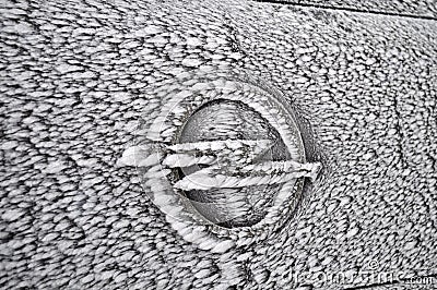 Completely frozen and snow-covered passenger car in a parking lot in winter in a thick fog Editorial Stock Photo