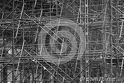 Complicated scaffolding consisting of many poles and struts inside a historic building, black and white Stock Photo