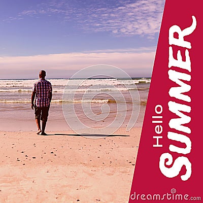 Composite of hello summer text and rear view of african american man walking at sandy beach Stock Photo