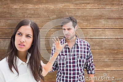 Composite image of angry brunette not listening to her boyfriend Stock Photo