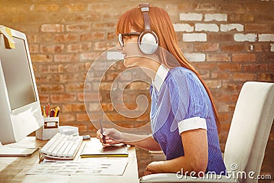 Composite image of attractive hipster woman with headset using graphics tablet Stock Photo