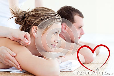 Composite image of attractive young couple having an acupunctre therapy Stock Photo