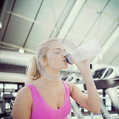 Composite image of beautiful healthy woman drinking water Stock Photo