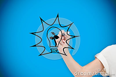 Composite image of businesswoman drawing light bulb Stock Photo