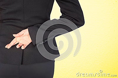 Composite image of businesswoman with fingers crossed behind her back Stock Photo