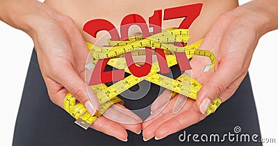 Composite image of close-up mid section of a woman measuring waist Stock Photo