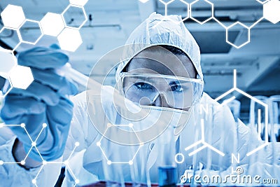 Composite image of close up of a protected science student dropping liquid in a test tube Stock Photo