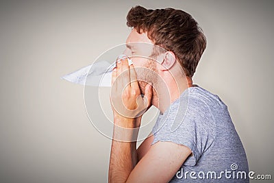 Composite image of close up side view of man blowing nose Stock Photo