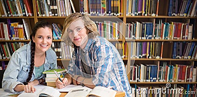 Composite image of college students doing homework in library Stock Photo