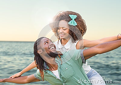 Composite image of Couple against sea with flare Stock Photo